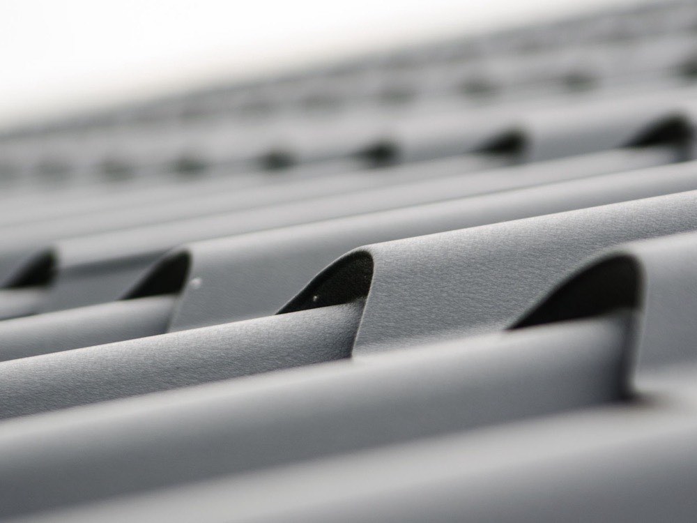Close-up of gray metal roof panels with a matte finish
